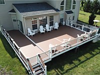 <b>Trex Select Saddle Composite Deck with White Washington Vinyl Railing with round aluminum balusters and a matching drink rail</b>
